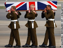 A coffin draped in the British flag is carried from a military cargo plane at Brize Norton Royal Air Force Base in England on Saturday.